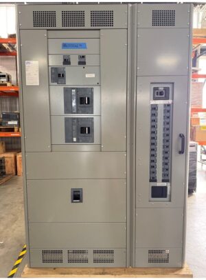 67Panelboard - Siemens Feeder and Lighting - Coastal Power Systems Industrial electrical cabinet with multiple breakers and a vertical load-center panel, mounted on a wooden base in a warehouse.